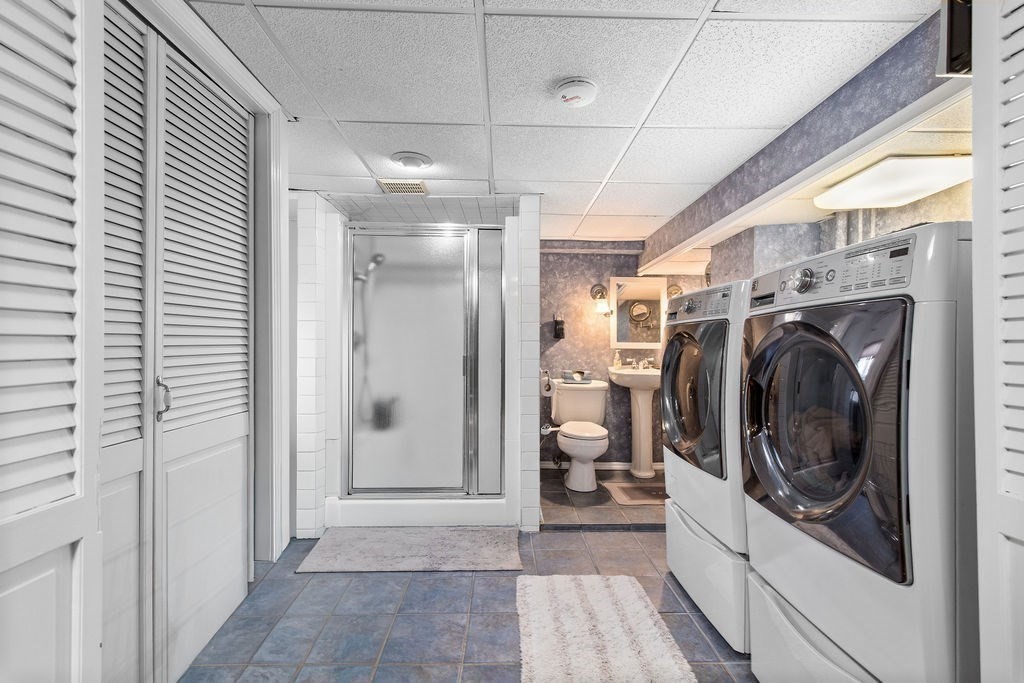 71 Pond Lane Randolph, MA 02368 - Photo 25 of 35 a view of a hallway with washer and dryer