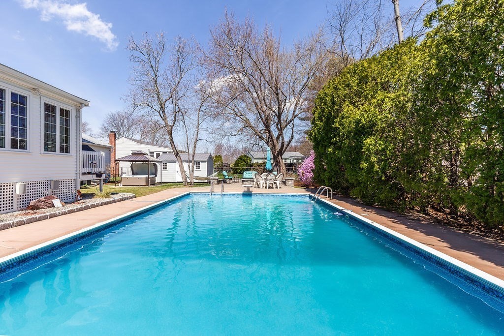 71 Pond Lane Randolph, MA 02368 - Photo 27 of 35 a swimming pool with outdoor seating and yard