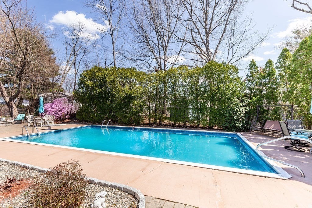 71 Pond Lane Randolph, MA 02368 - Photo 28 of 35 a view of a swimming pool and lounge chairs