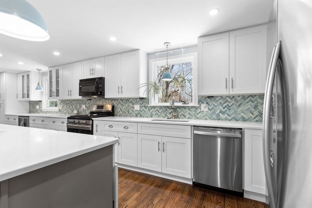 71 Pond Lane Randolph, MA 02368 - Photo 6 of 35 a kitchen with granite countertop white cabinets and stainless steel appliances