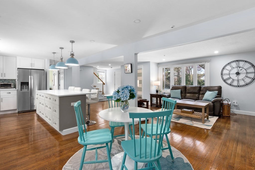 71 Pond Lane Randolph, MA 02368 - Photo 9 of 35 a view of a dining room with furniture a kitchen and chandelier
