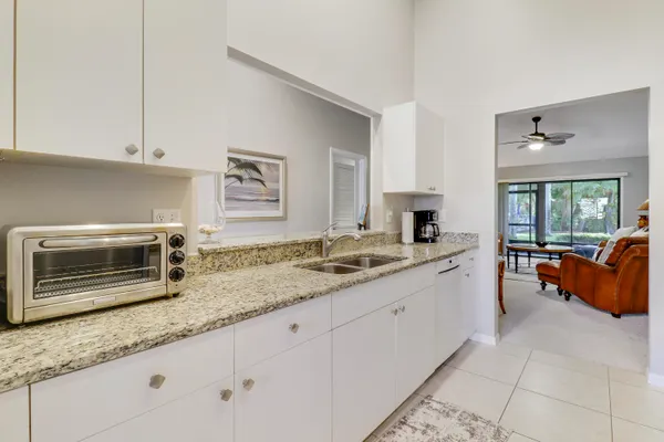 a kitchen with stainless steel appliances granite countertop a sink and a microwave