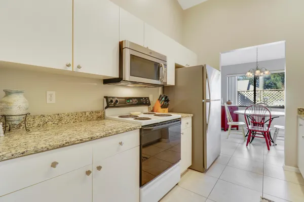 a kitchen with stainless steel appliances granite countertop a stove refrigerator sink and cabinets