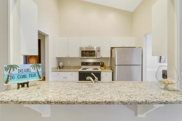 a kitchen with a refrigerator sink and a stove