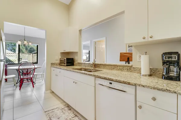 a large kitchen with granite countertop a stove a sink and a granite counter tops