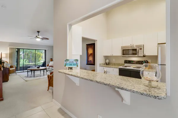 a kitchen with granite countertop lots of counter top space and stainless steel appliances