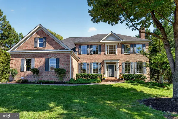 a front view of a house with a yard and porch