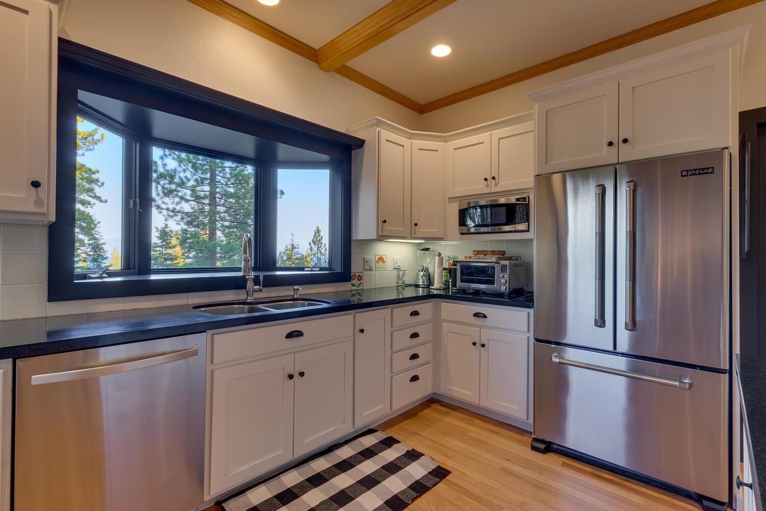 260 Old County Road Carnelian Bay, CA 96140 - Photo 16 of 28 a kitchen with granite countertop stainless steel appliances a refrigerator sink and cabinets