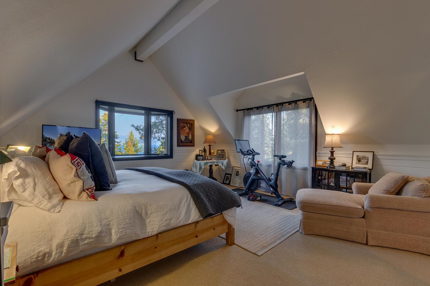260 Old County Road Carnelian Bay, CA 96140 - Photo 22 of 28 a bedroom with bed a mirror and a couch