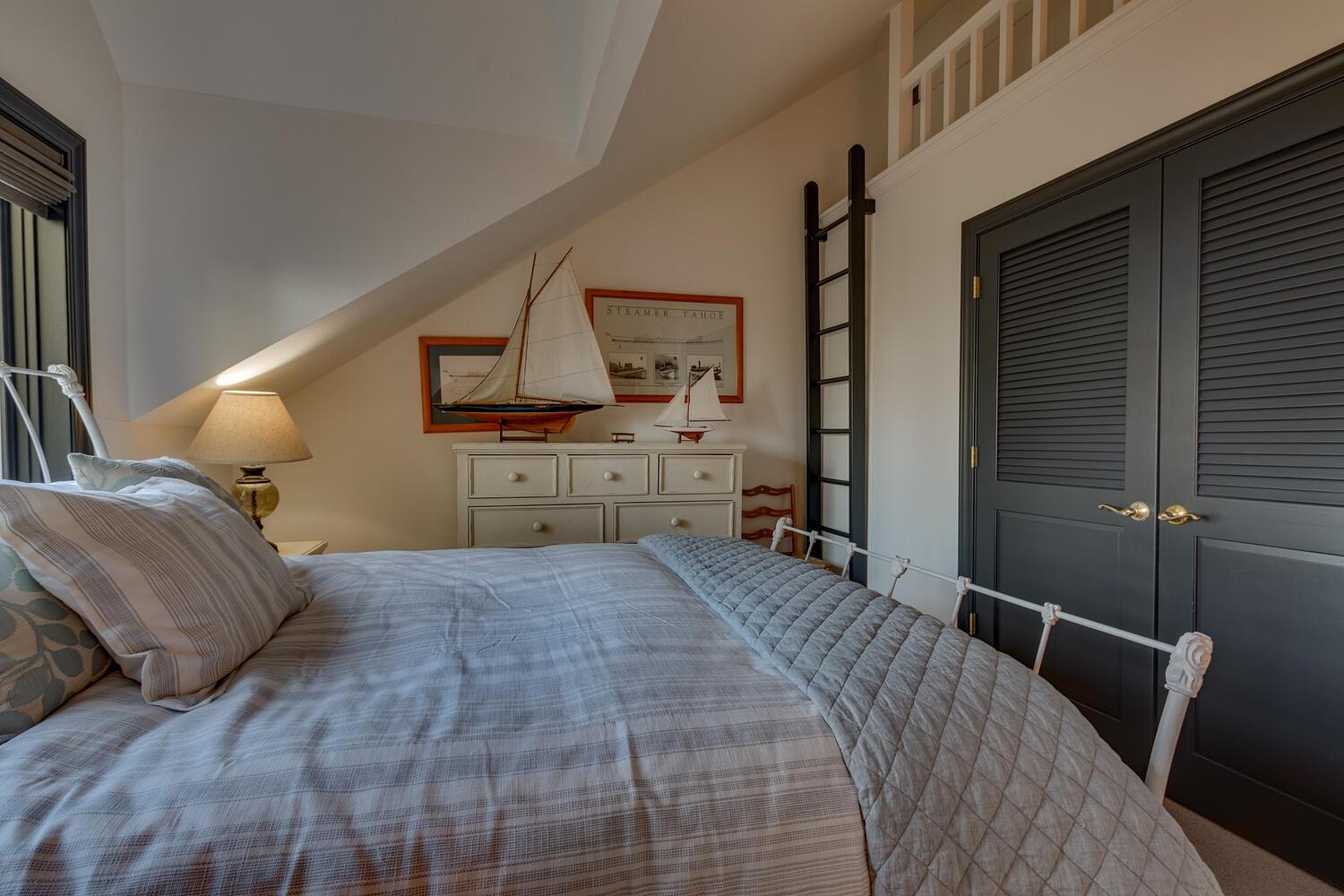 260 Old County Road Carnelian Bay, CA 96140 - Photo 27 of 28 a bed room with a bed window and mirror