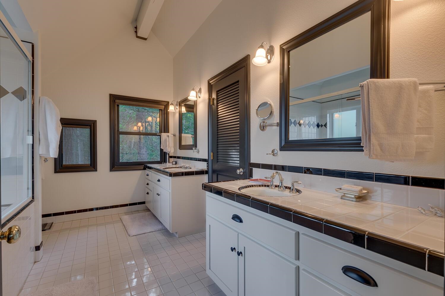 260 Old County Road Carnelian Bay, CA 96140 - Photo 28 of 28 a bathroom with a double vanity sink and mirror with bathtub