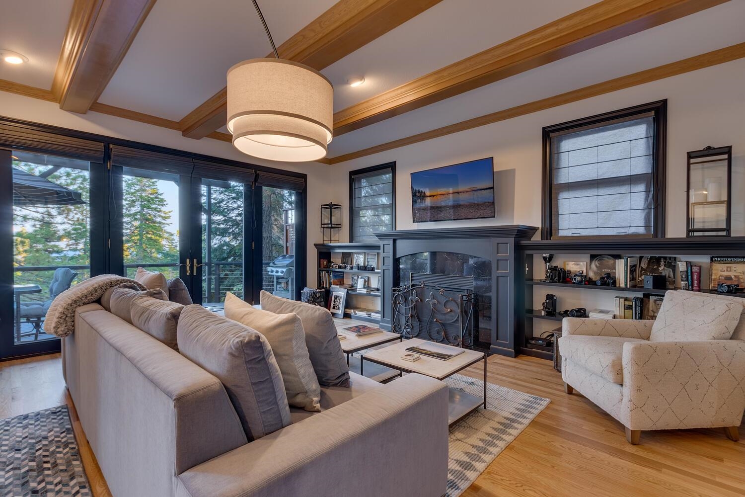 260 Old County Road Carnelian Bay, CA 96140 - Photo 8 of 28 a living room with furniture a fireplace and a large window