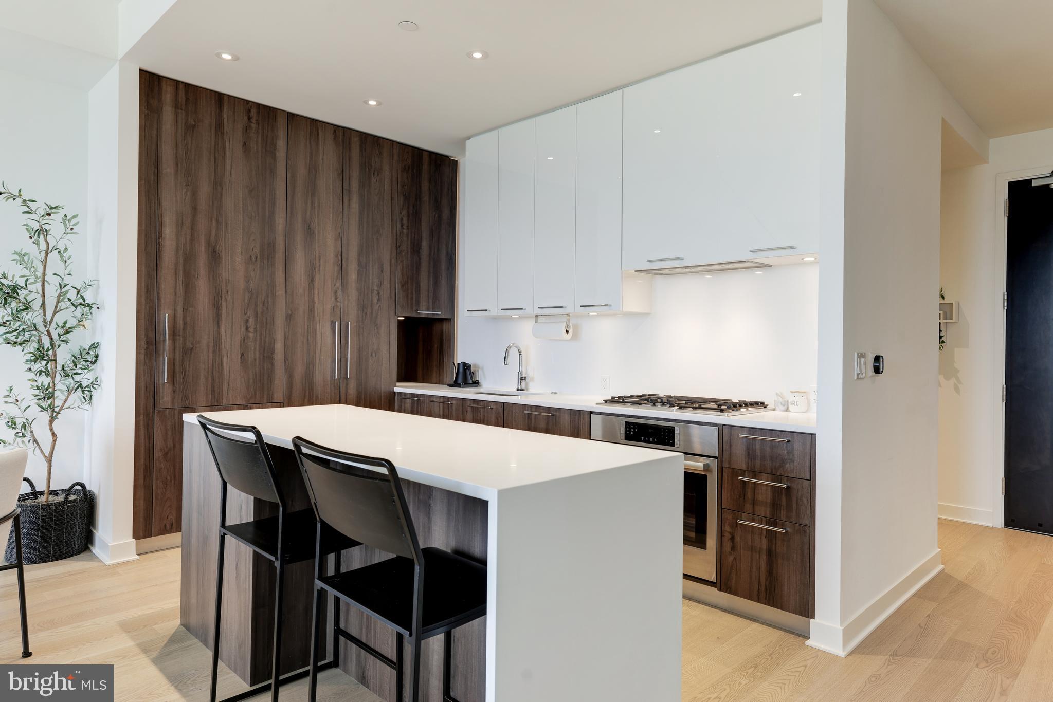 1650 Silver Hill Drive, Unit 23091 McLean, VA 22102 - Photo 19 of 86 a kitchen with stainless steel appliances a table chairs and a refrigerator