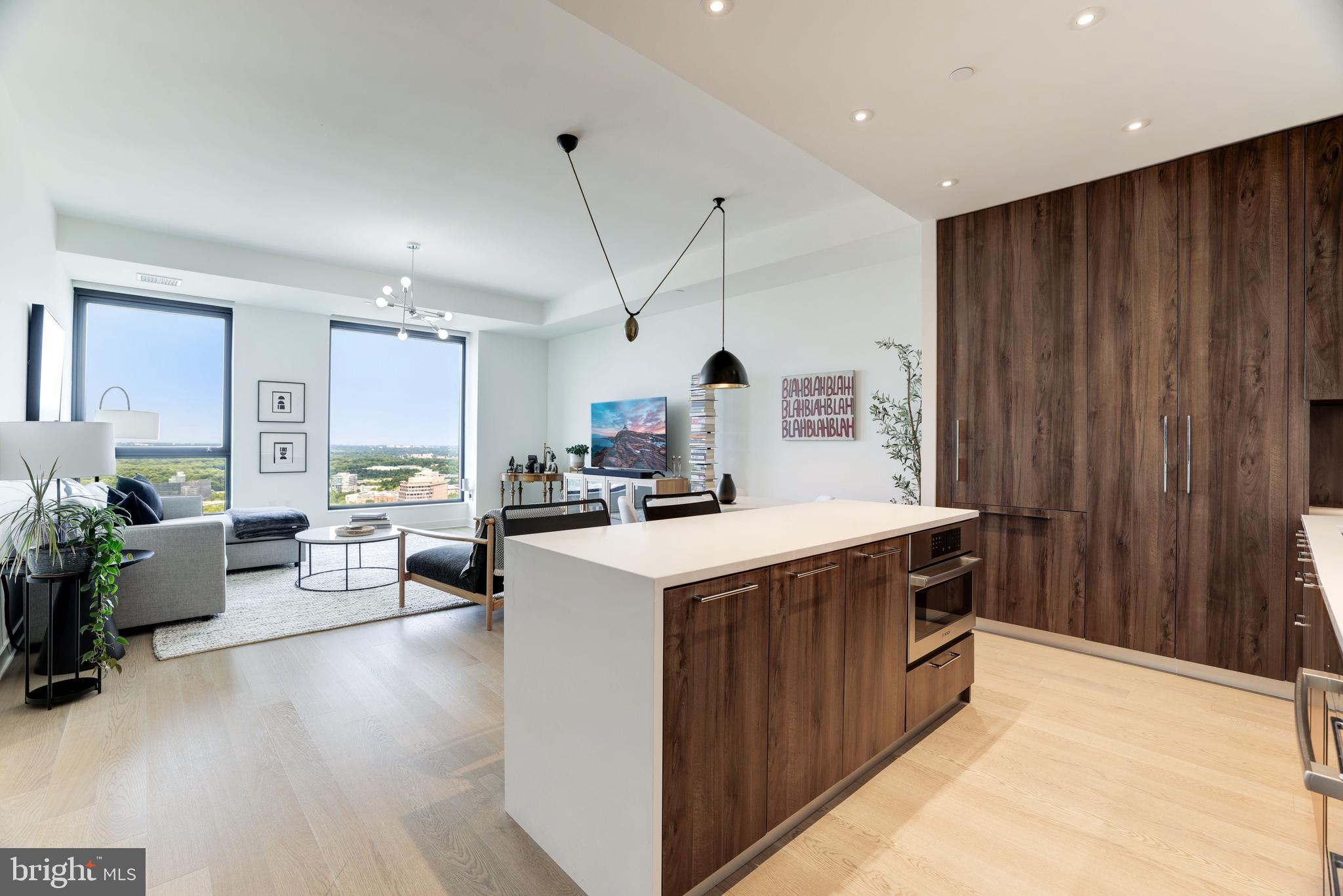 1650 Silver Hill Drive, Unit 23091 McLean, VA 22102 - Photo 24 of 86 a kitchen that has a lot of cabinets a sink and a wooden floor in it