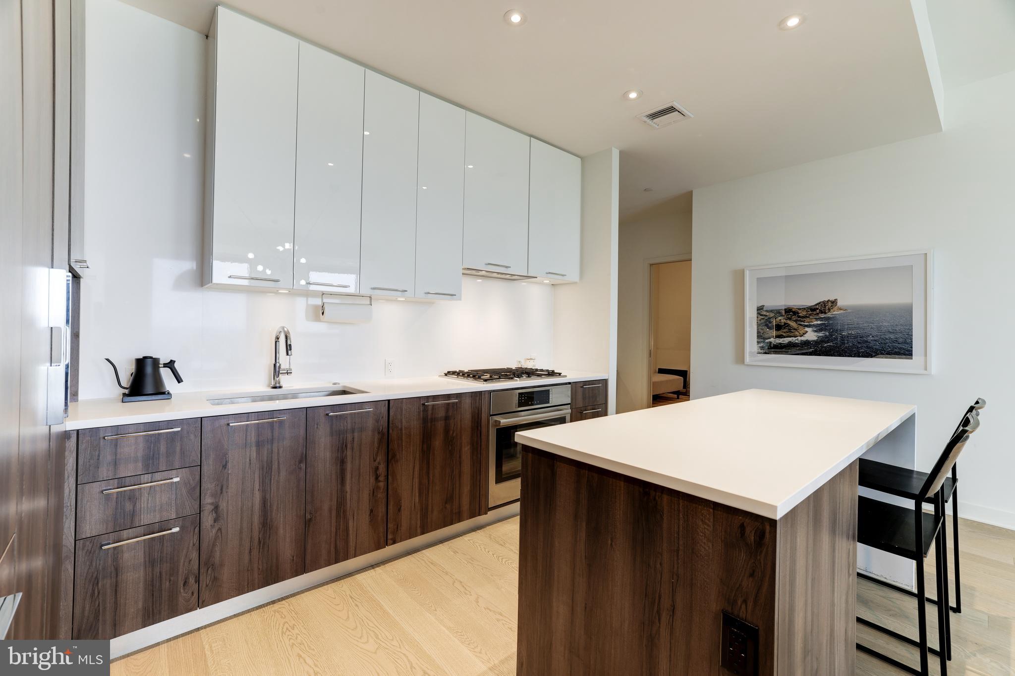 1650 Silver Hill Drive, Unit 23091 McLean, VA 22102 - Photo 25 of 86 a kitchen with stainless steel appliances a stove a sink dishwasher and a refrigerator with wooden floor