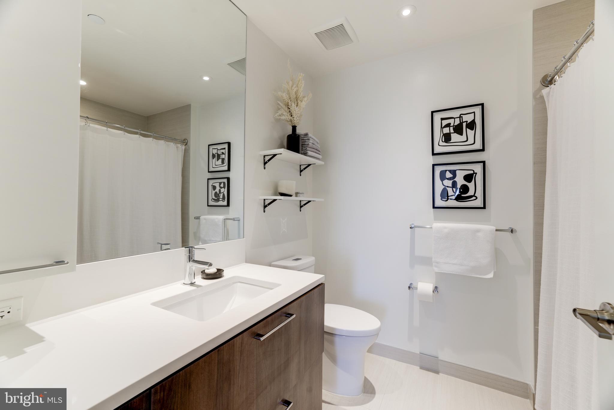 1650 Silver Hill Drive, Unit 23091 McLean, VA 22102 - Photo 38 of 86 a bathroom with a sink toilet and shower