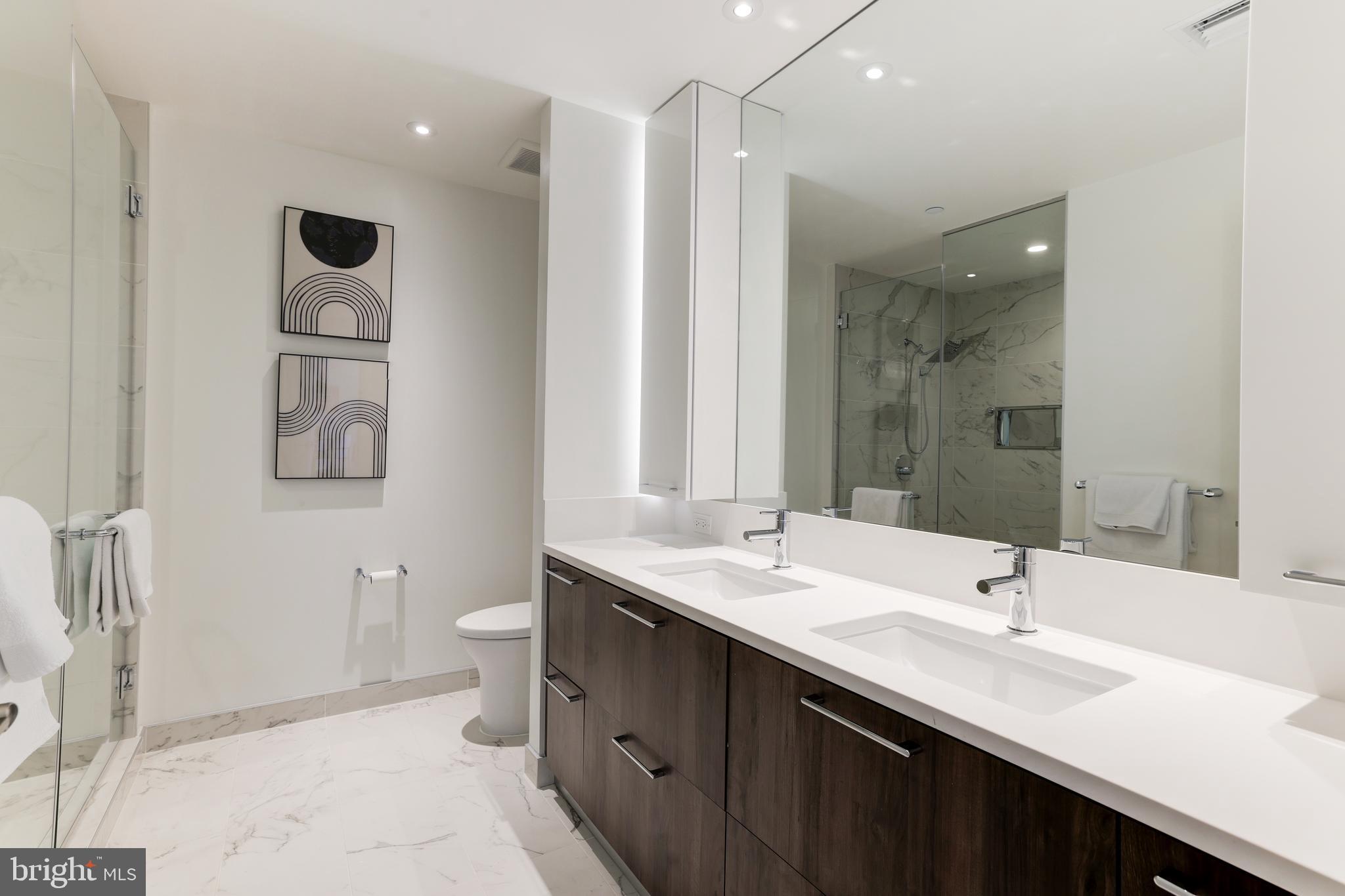 1650 Silver Hill Drive, Unit 23091 McLean, VA 22102 - Photo 41 of 86 a bathroom with a double vanity sink toilet and a mirror