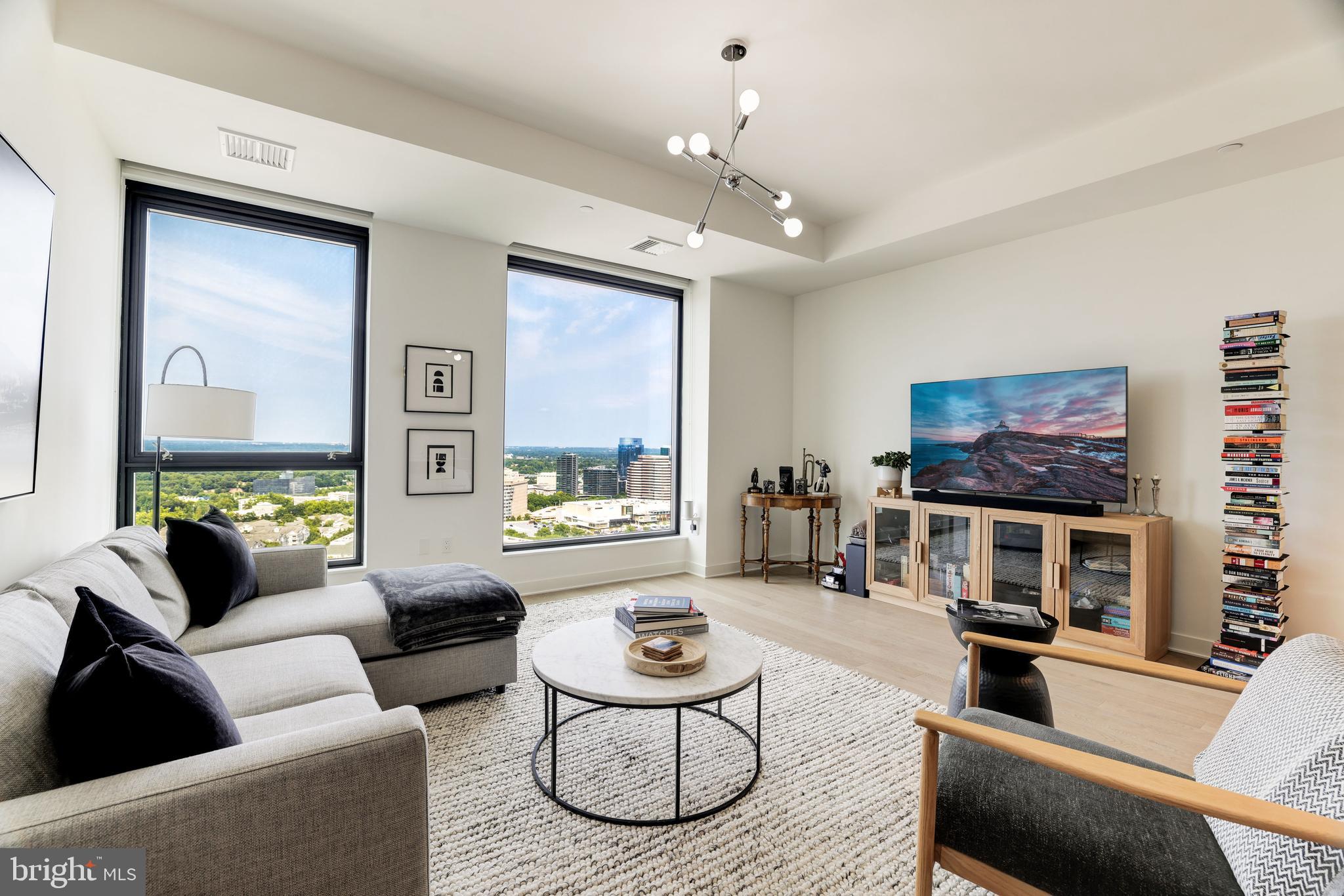 1650 Silver Hill Drive, Unit 23091 McLean, VA 22102 - Photo 5 of 86 a living room with furniture a flat screen tv and a large window
