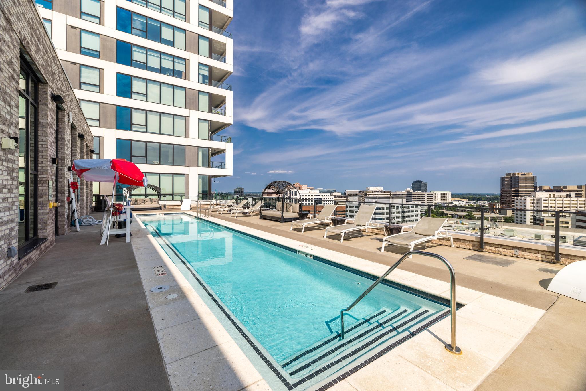 1650 Silver Hill Drive, Unit 23091 McLean, VA 22102 - Photo 62 of 86 a view of a swimming pool with a lounge chair