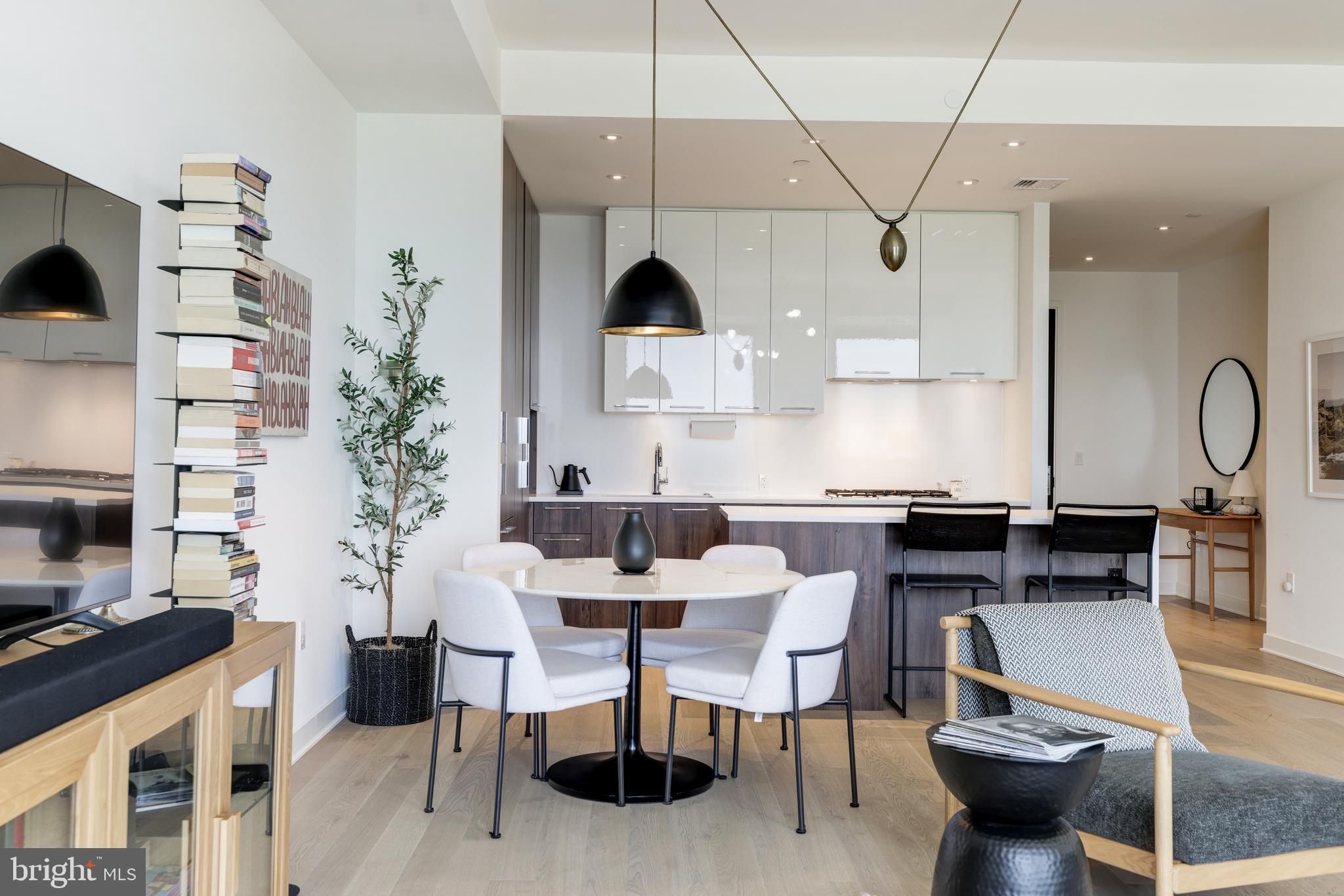 1650 Silver Hill Drive, Unit 23091 McLean, VA 22102 - Photo 10 of 86 a kitchen with stainless steel appliances kitchen island granite countertop a table chairs stove a sink and dishwasher
