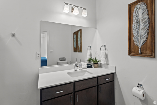 1122 South 1790th Street West, Unit 2 St. George, UT 84770 - Photo 9 of 37 Bathroom vanity with a white countertop and dark wood-finish cabinetry