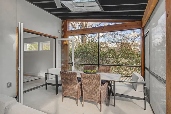 a view of a room with a table and chairs