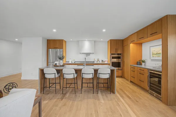 a large kitchen with a table and chairs