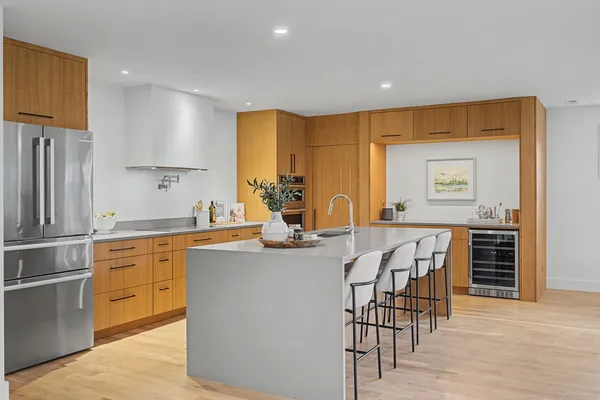 a kitchen with stainless steel appliances kitchen island granite countertop a sink and cabinets