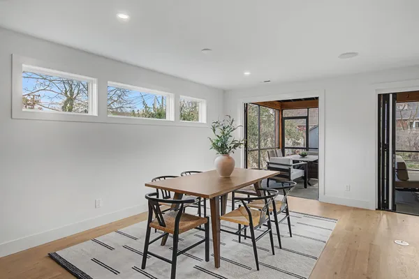 a view of a dining room with furniture and wooden floor