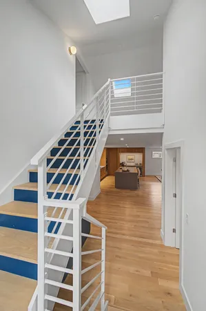 a view of a livingroom with wooden floor and white walls