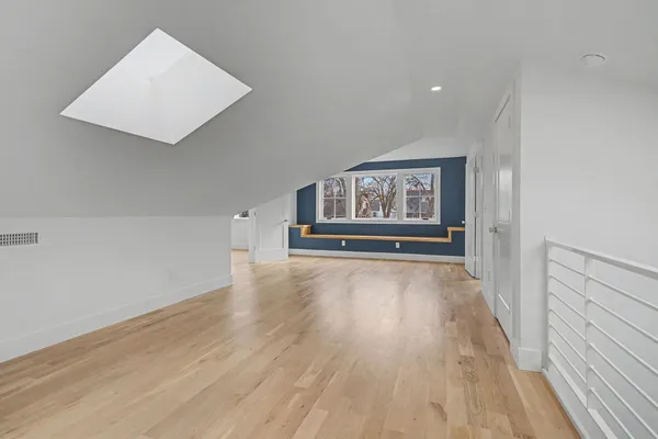 wooden floor in a hall with an empty room