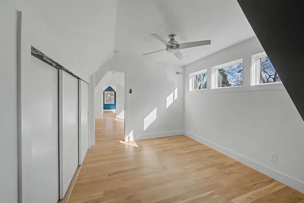 a view of an empty room with wooden floor
