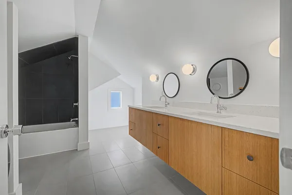 a bathroom with a double vanity sink and mirror