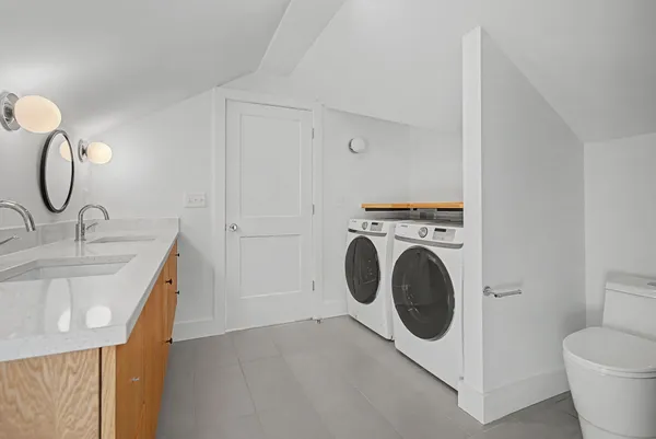 a utility room with sink dryer and washer