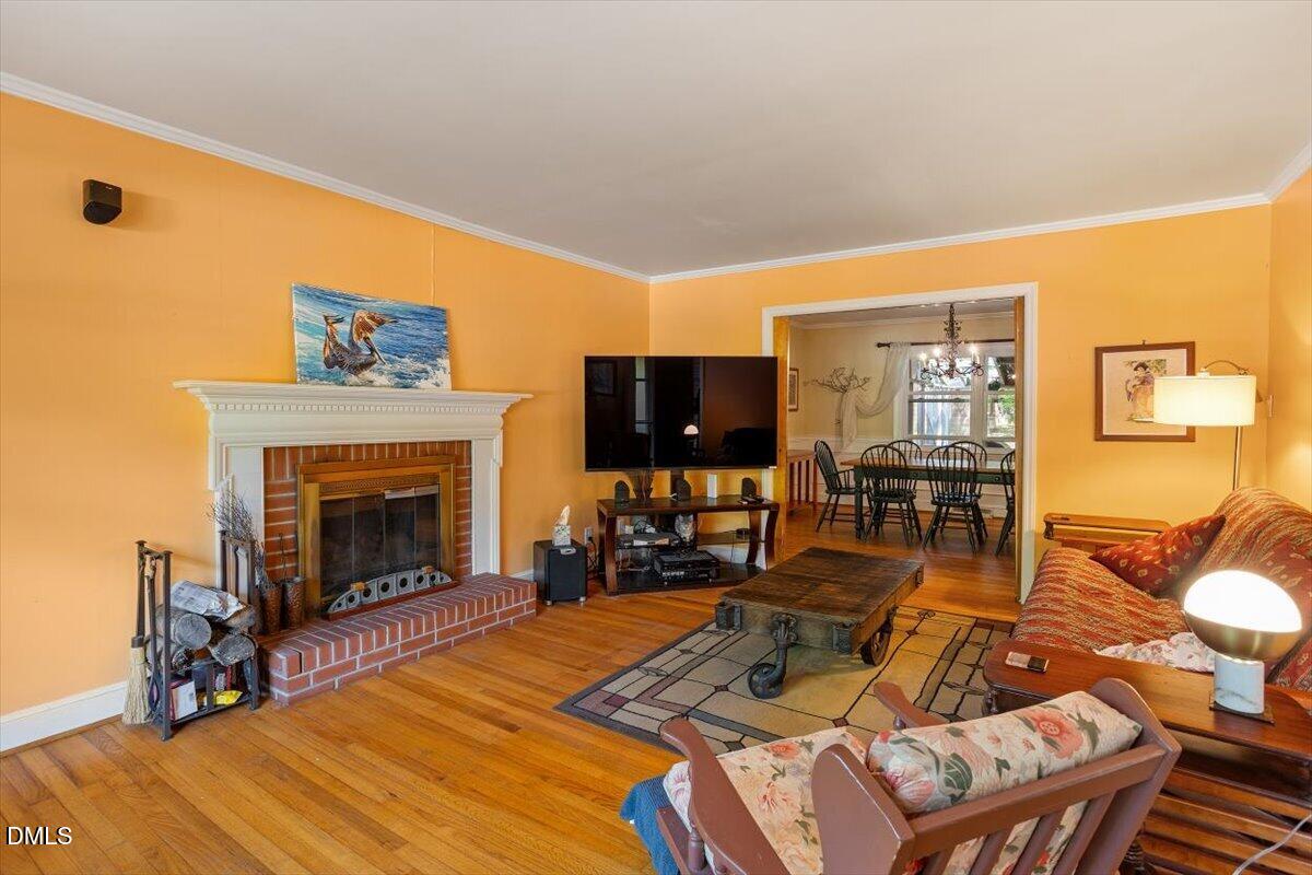 3107 Dixon Road Durham, NC 27707 - Photo 3 of 35 a living room with furniture a flat screen tv and a fireplace