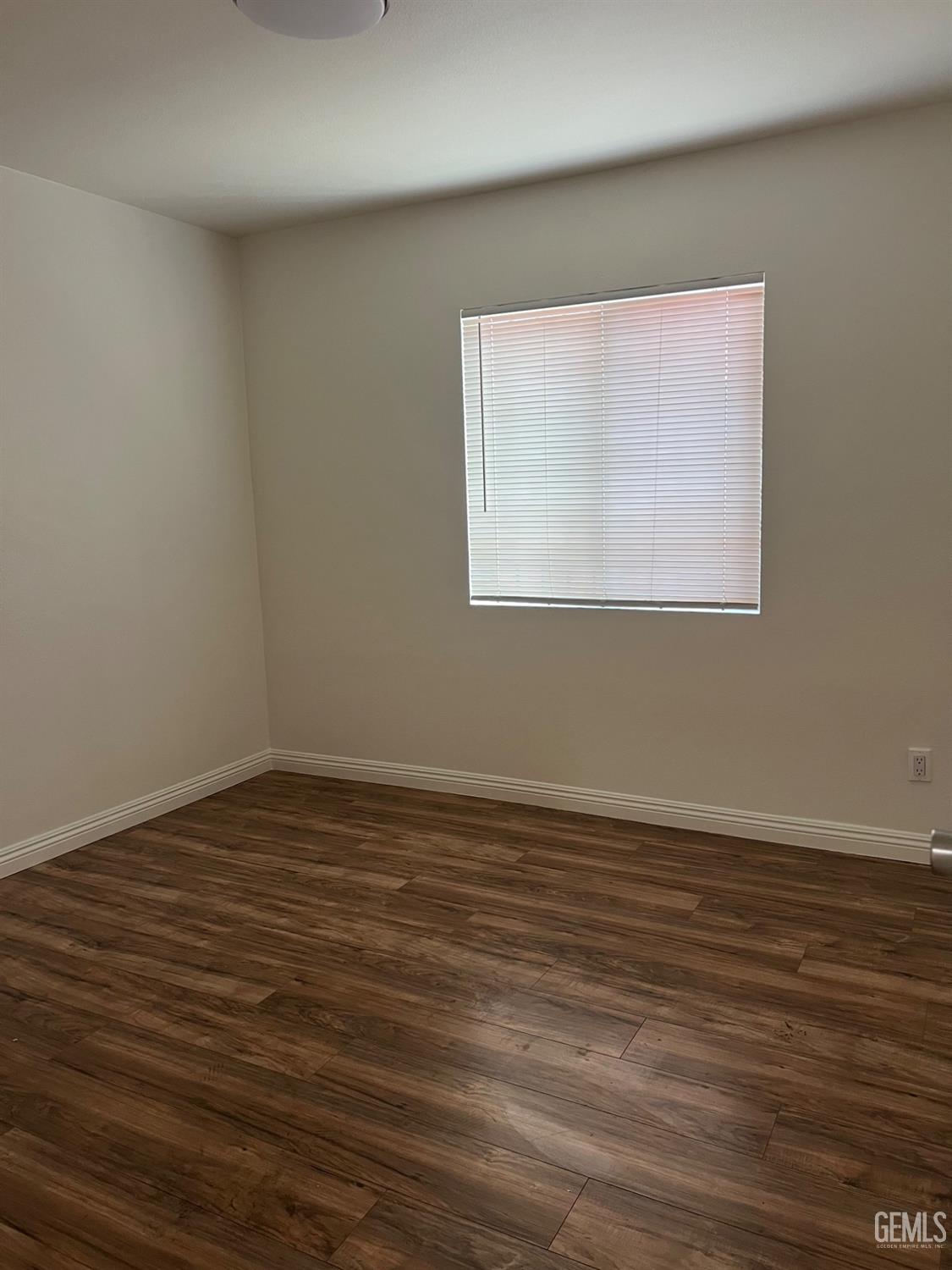 Undisclosed Address Bakersfield, CA 93304 - Photo 12 of 22 a view of an empty room with wooden floor and a window