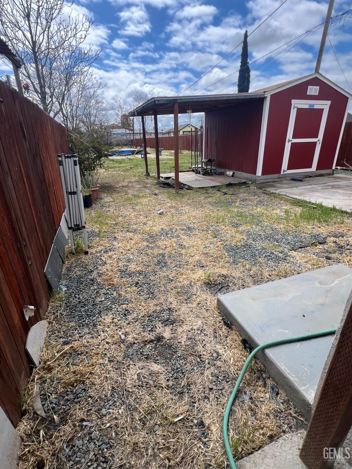 Undisclosed Address Bakersfield, CA 93304 - Photo 19 of 22 a view of a backyard with wooden fence