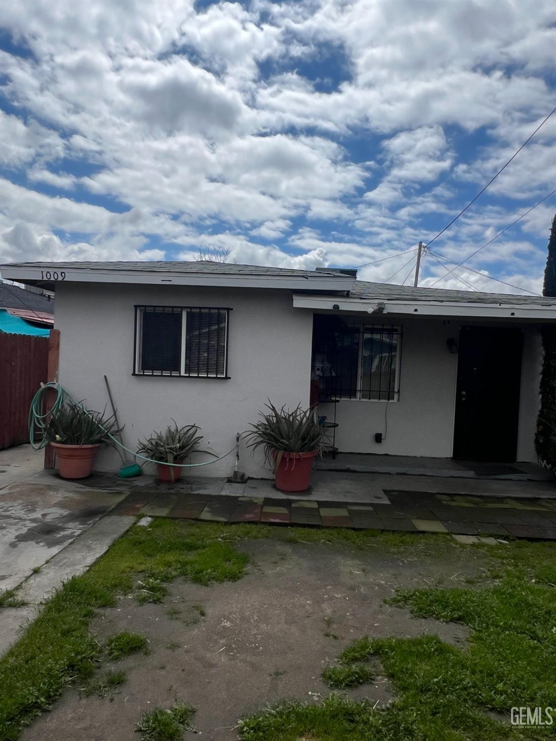 Undisclosed Address Bakersfield, CA 93304 - Photo 2 of 22 a front view of house with yard