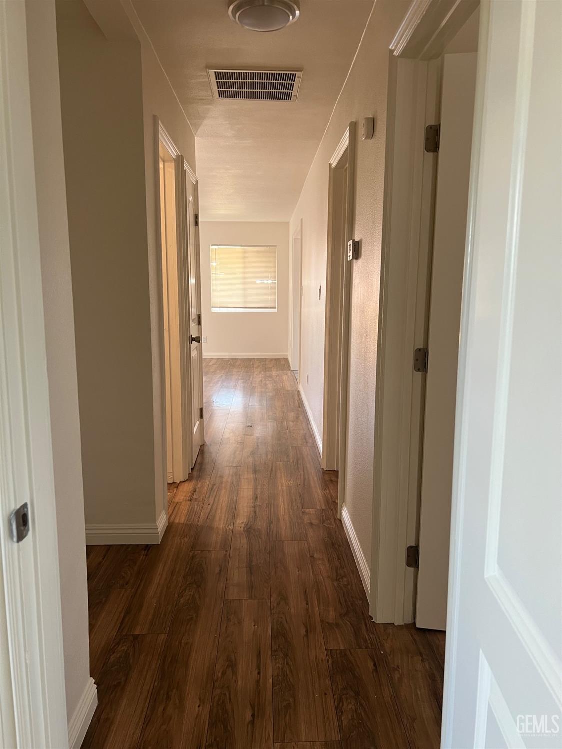 Undisclosed Address Bakersfield, CA 93304 - Photo 9 of 22 a view of a hallway with wooden floor