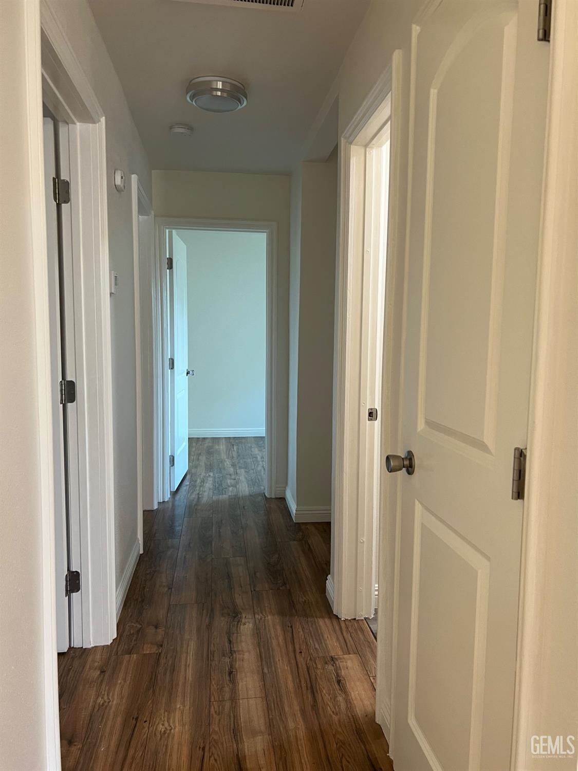 Undisclosed Address Bakersfield, CA 93304 - Photo 10 of 22 a view of a hallway with wooden floor