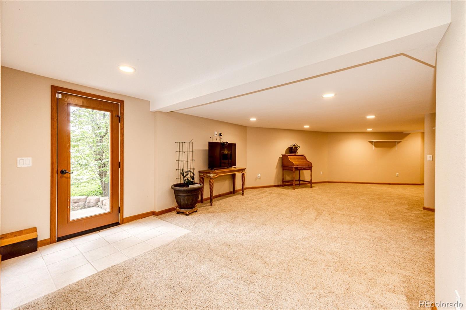 8788 East Tanglewood Road Franktown, CO 80116 - Photo 19 of 48 a view of a livingroom with a flat screen tv and dresser
