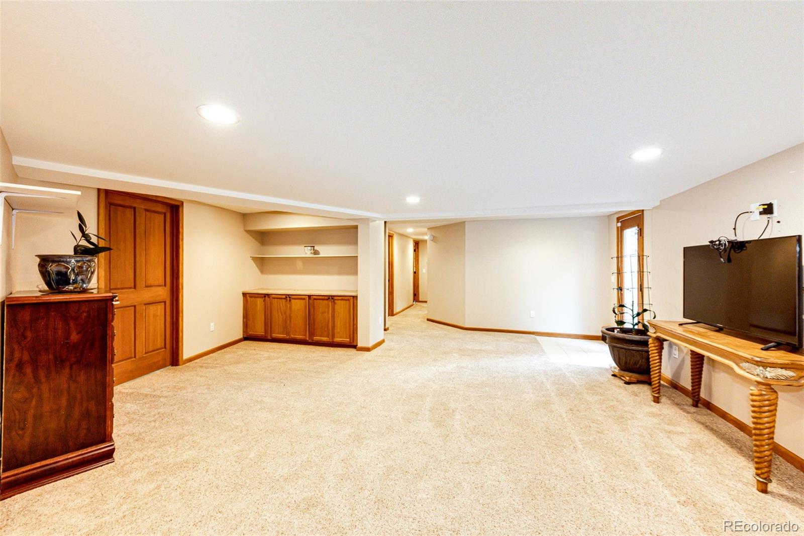 8788 East Tanglewood Road Franktown, CO 80116 - Photo 21 of 48 a room with furniture and a flat screen tv