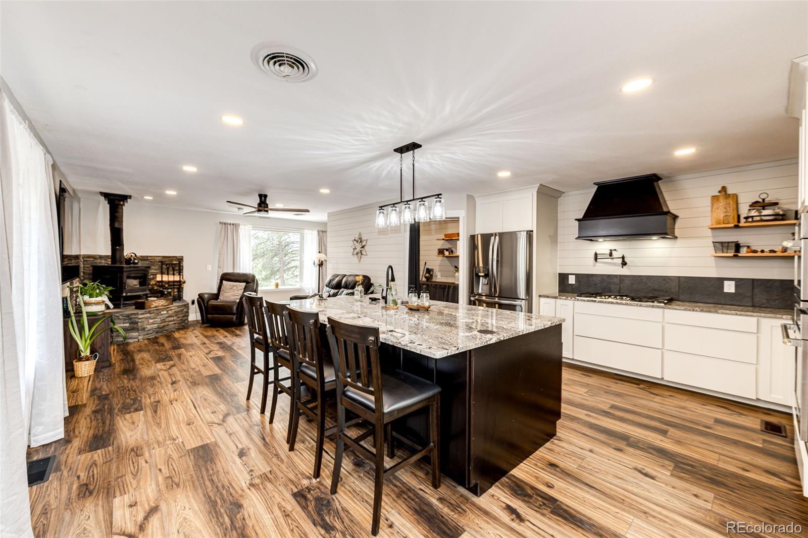 8788 East Tanglewood Road Franktown, CO 80116 - Photo 29 of 48 a kitchen with lots of counter top space and furniture