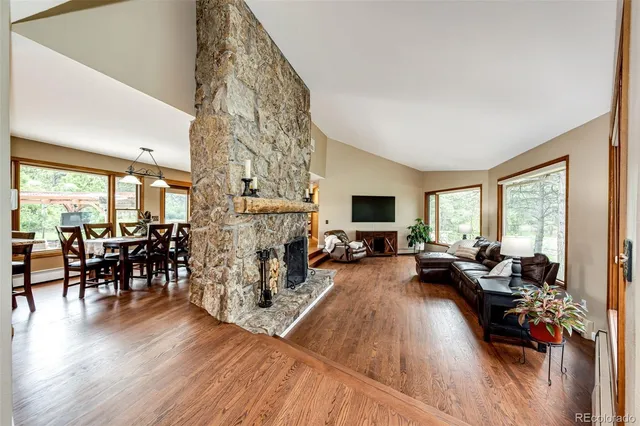 a living room with fireplace furniture and a wooden floor