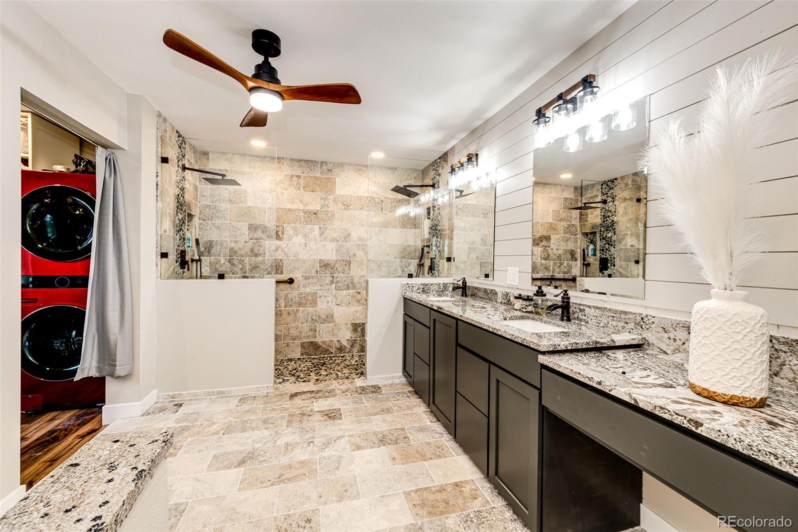 8788 East Tanglewood Road Franktown, CO 80116 - Photo 32 of 48 a kitchen with stainless steel appliances kitchen island granite countertop a sink and cabinets