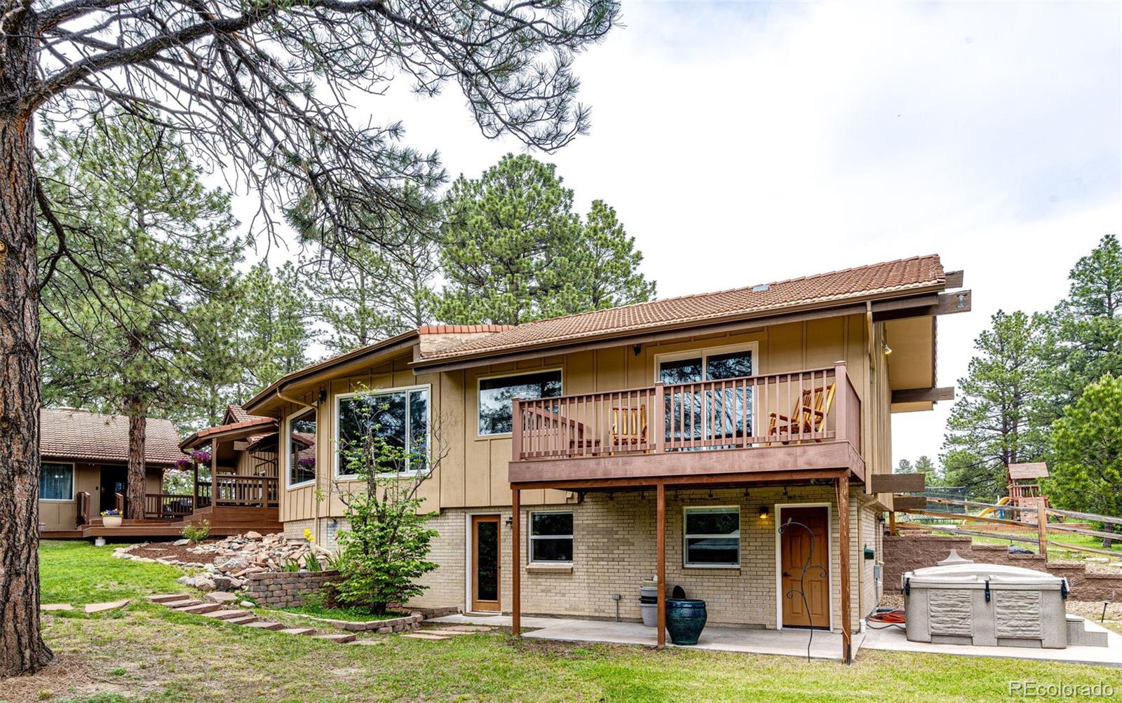 8788 East Tanglewood Road Franktown, CO 80116 - Photo 34 of 48 a front view of a house with garden
