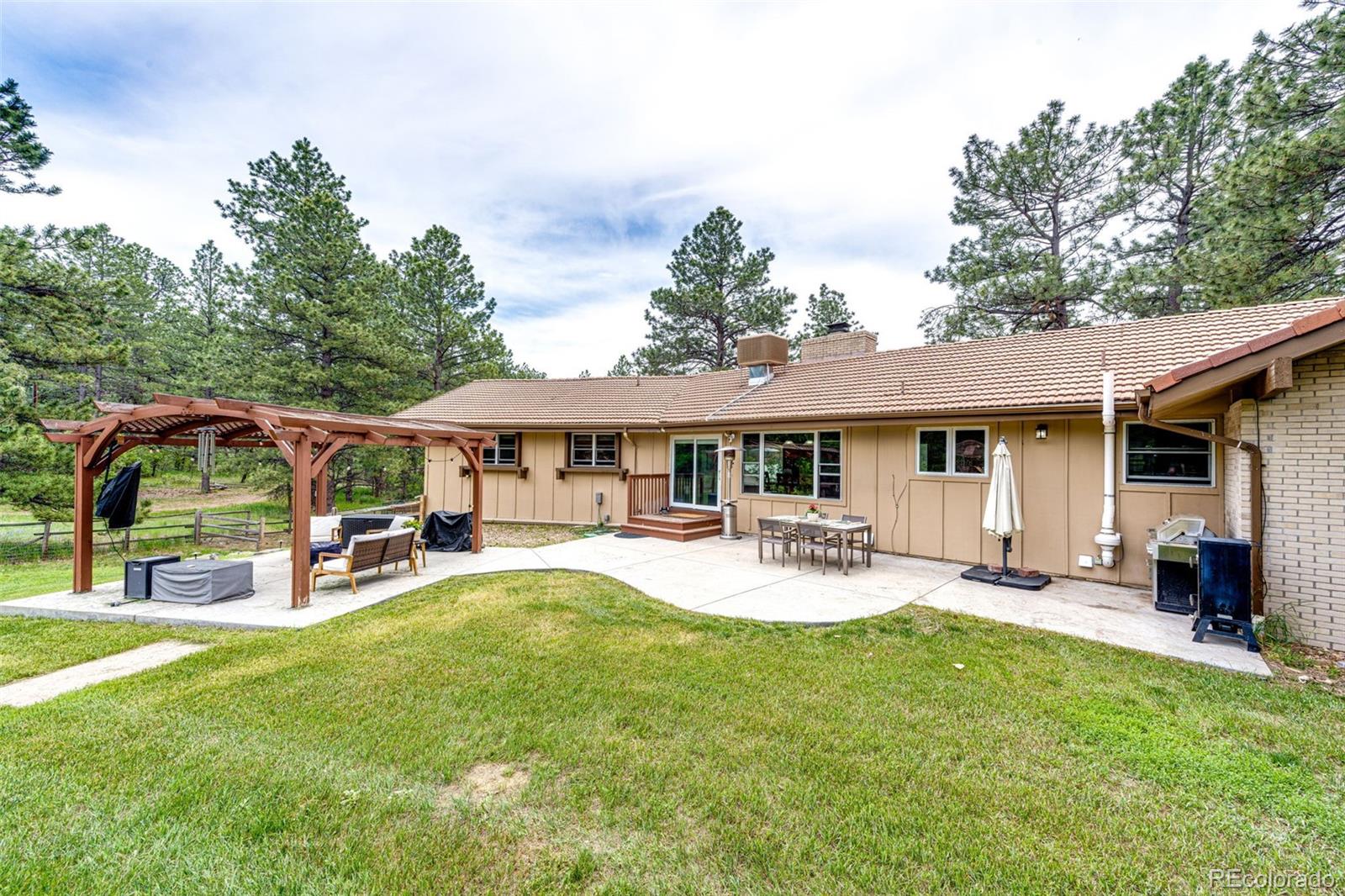 8788 East Tanglewood Road Franktown, CO 80116 - Photo 36 of 48 a view of a house with backyard and sitting area
