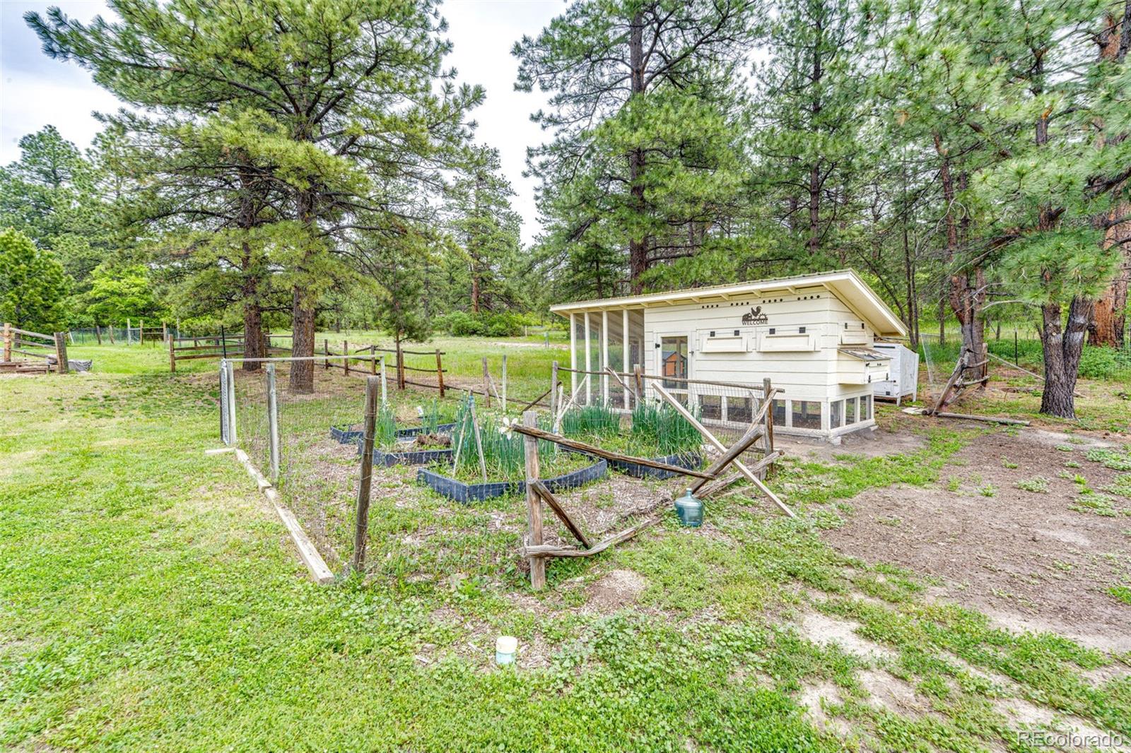 8788 East Tanglewood Road Franktown, CO 80116 - Photo 37 of 48 a view of a house with backyard and a slide