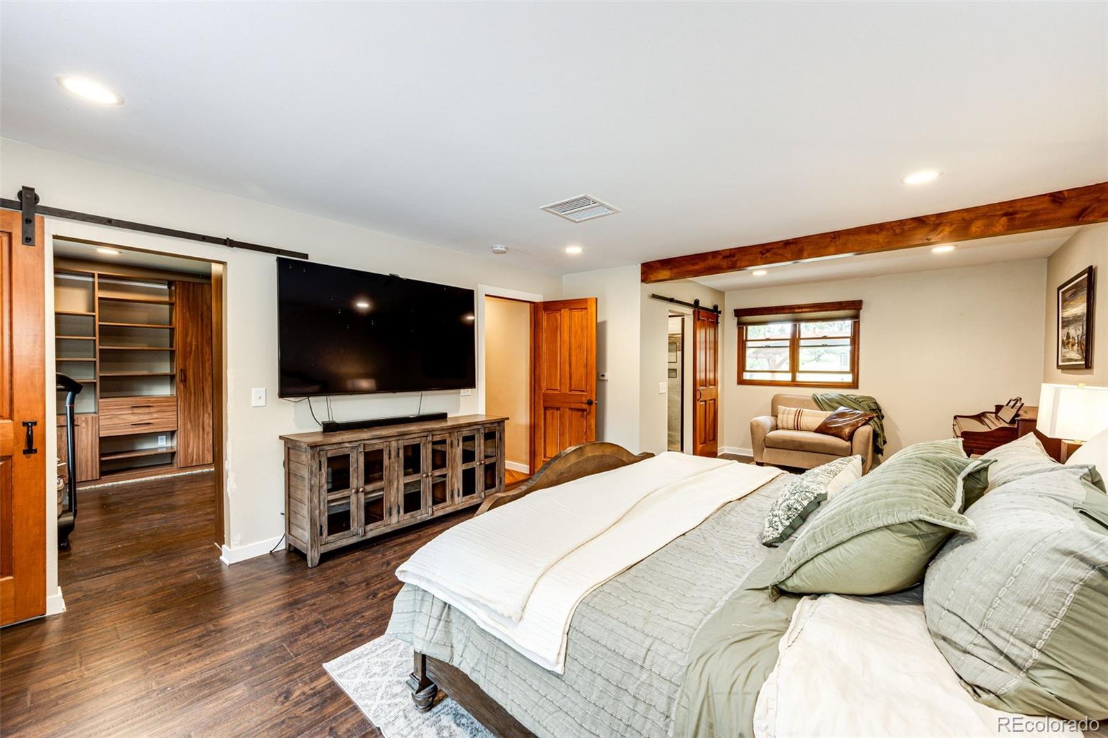 8788 East Tanglewood Road Franktown, CO 80116 - Photo 6 of 48 a bedroom with a bed and a flat screen tv