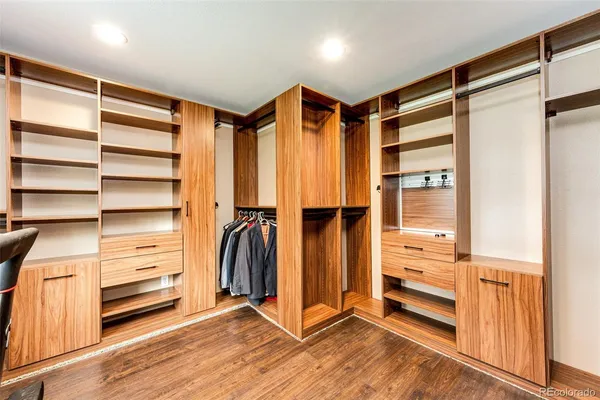 a view of walk in closet with empty racks